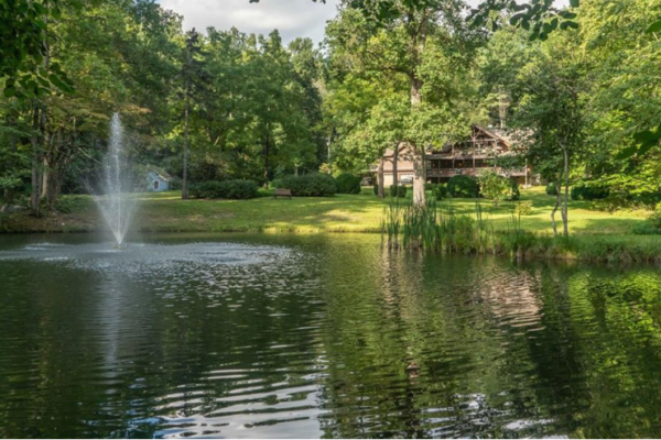 home in distance over pond with water, alleghany county homes for sale, homes for sale in alleghany county nc, alleghany county real estate, alleghany nc mountain homes, nc high country real estate, homes for sale in sparta nc, sparta nc real estate, roaring gap homes for sale, laurel springs nc real estate, glade valley nc homes, mountain homes in alleghany county, cabins for sale in alleghany nc, new river homes nc, blue ridge parkway real estate, north carolina mountain homes for sale, nc mountain property, log cabins for sale in nc, riverfront property in alleghany county, nc real estate agent lori eastridge, vacation homes in nc mountains